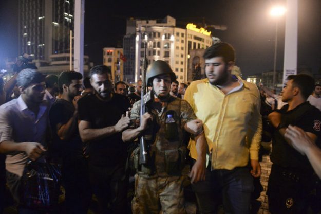 A Turkish soldier, arrested by civilians, is walked to be handed to police officers, in Istanbul's Taksim square, early Saturday, July 16, 2016. Members of Turkey's armed forces said they had taken control of the country, but Turkish officials said the coup attempt had been repelled early Saturday morning in a night of violence, according to state-run media. (AP Photo/Selcuk Samiloglu)