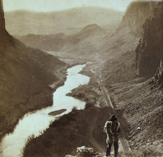 A Native American overlooking the newly completed transcontinental railroad in 1868